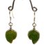 "Sound of the Ocean" earrings by Liuli Gong Fang. Made in sterling silver and green pâte-de-verre crystal in the form of a shell. Drop length approximately 40mm. Main photo of earrings displayed on a stand and facing forward.