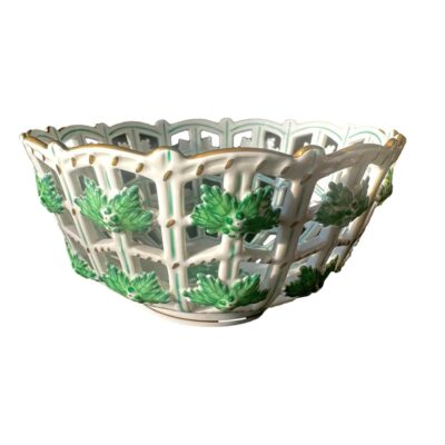 A vintage porcelain hand-painted bowl of lattice open work design by Herend of Hungary. Main photo looking at bowl from an eye level angle showing the lattice design and leaf decorations.