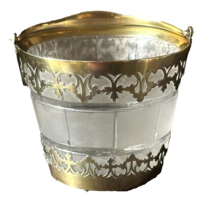 A Victorian silver gilt ice bucket with frosted glass barrel. It is hallmarked for 1885 London and made by George Fox. There is a slight loss of gilt from the inside rim and a slight indentation in the silver just above the base (please see last photo). A minor repair has been made to stick some of the silver gilt to the glass and a nut based glue has been used. We therefore recommend this item not be used for nut allergy sufferers. The barrel of the ice bucket is 90 mms high, 112mms in diameter across the top and the handle is 12mms at its widest width. Photo of bucket seen in a little more close up with the handle down and to the back.
