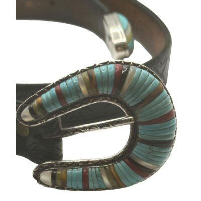 Vintage Native American Zuni multi stone inlay sterling silver belt. The buckle and fittings are set with turquoise, mother of pearl , onyx & coral. The reverse of the clasp is stamped sterling. The buckle measures 60 x 45 x 11 mms. Close up photo of the horseshoe shape main buckle of the belt which has multiple semi precious stones consisting mostly of turquoise.