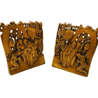 Pair of Chinese late 19th century wooden bookends. Main photo of both bookends shown side by side. Wonderfully detailed mirrored carving of Chinese nobleman with 2 escorts and a kneeling woman with bowed head. Background of pagoda style buildings and bamboo. Incredible eye to detail.