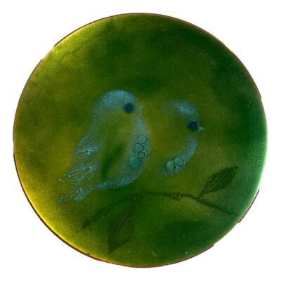 Small mid century enamel on copper plate by Judith Wedemeier USA c1960s. Beautiful green enamel dish decorated with 2 pale blue birds sat on a branch with raised bubble accents for the birds eyes and breasts. Signed Wedemeier USA to the base. There are 3 shallow indents to the base possibly from manufacturing process. Measures 125mm in diameter. Main photo of whole dish with whole image of the 2 little blue birds shown.