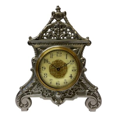 Early 20th century antique 'Strut' timepiece in good working order. Should be fully wound every days. Clock face measures 85mm in diameter. Finial at the very top of the clock frame is a little bent otherwise in excellent condition throughout. Fully serviced and guaranteed for 1 year. COLLECT FROM STORE ONLY. Main photo of the clock seen from the front with the slightly bent finial at top visible.