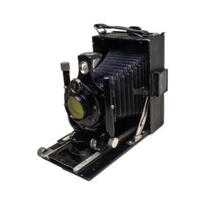 A Voigtlander Vag folding camera for 120 film and quarter plate film. Made circa 1930. Voigtlander Voigtar Anastigmat f4.5 lens. Photo of camera seen with front end concertina open and facing the bottom left corner of photo.