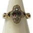 A 9ct gold Gypsy ring size M with a colourful Mystic stone and diamond setting. Main photo of ring on a cone shaped display stand with ring front facing forward.