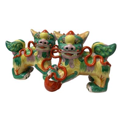 Pair of vintage Dogs of Foo in not often seen vibrant colours of green, pink, yellow & terracotta red. Both in very good condition. Each measures approximately 240mm at longest, 170mm at widest (front paws) and 210mm at highest. COLLECT FROM STORE ONLY. Photo of both dogs placed with male with ball in front of female.