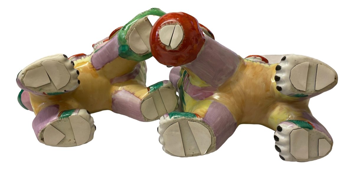 Pair of vintage Dogs of Foo in not often seen vibrant colours of green, pink, yellow & terracotta red. Both in very good condition. Each measures approximately 240mm at longest, 170mm at widest (front paws) and 210mm at highest. COLLECT FROM STORE ONLY. Photo of the dogs laid on their side to reveal bottom. The paws have had padding added to protect furniture.