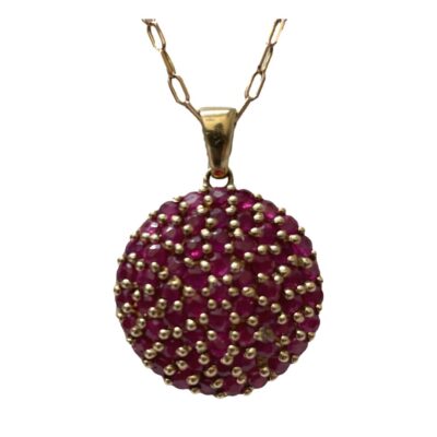 Modern 9 karat gold circular pendant embedded with a multitude of round cut rubies. Hallmarked to the bail for Birmingham assay c2010. Pendant drop length approximately 25mm from top of bail with width of 28mm. Chain is hallmarked 375 to the clasp. Main photo showing a forward facing pendant and part of the chain.