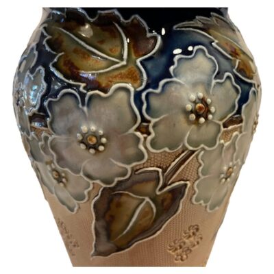 Antique Royal Doulton Lambeth Ware salt-glazed stoneware vase. Decorated by Emily Poubington and dated c1905. Measures 100mm in diameter at base. COLLECT FROM STORE ONLY. Close up photo of the floral decoration to the top of the vase.