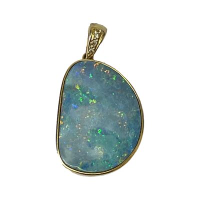 24 karat gold pendant with boulder opal. Stunning boulder opal with flashes of green and orange in a 14karat gold setting. The pendant bail has 3 small round cut diamonds for added sparkle.                                                      Pendant drop length 35mm from top of bail and 20mm at widest. Main photo showing pendant laid on a flat surface and seen looking straight down from above. The diamond in the bail is visible and the beautiful specks of colour in the opal.