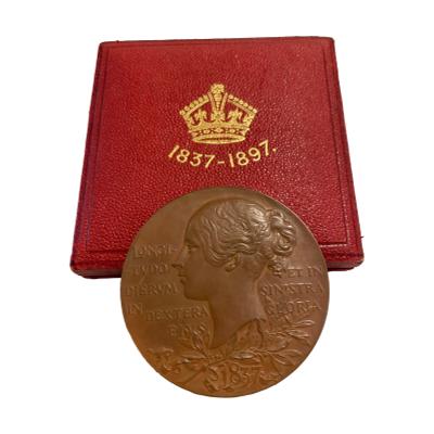 Queen Victoria commemorative medal for her diamond jubilee. A collectable bronze medal in original fitted case with a young Victoria c1837 to one side and reverse has image of the then queen in 1897. Medal measures 55mm in diameter. The clasp of the case is not working and does not close shut. Photo of medal leaning against the closed case and showing the young Victoria side.
