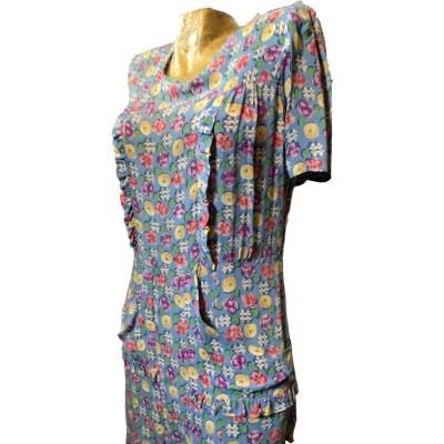 Beautiful petrol blue with unusual deco print, silky crepe dress. Button back, shirt sleeves and cute pockets either side. Dress at calf length and best for size 10 or small 12. In very good condition, no stains, holes etc. Photo of dress from thighs up with dress front facing slightly to the left.