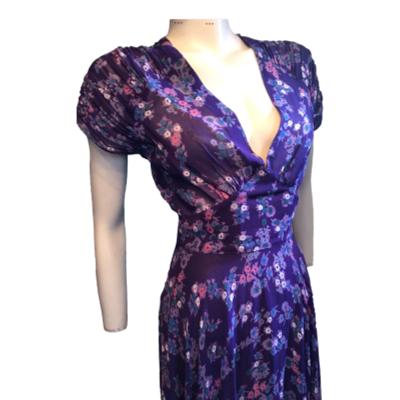 This is an original from the 1970s by infamous designer RADLEY who joined forces with OSSIE CLARK earlier in the 70s where he got his ideas. Plunging neckline and so much fabric in the skirt in a fine purple chiffon crepe and lined. Quite long probably ankle length on most. No faults in good condition. Size 8. Photo of front of dress from thighs up. Dress front is facing slightly to the right.