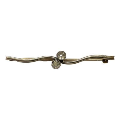 Edwardian 18 karat gold twist brooch with .40 carat diamond. Elegant bar brooch with 18 karat white gold twist front set with 2 old cut round diamonds. Back of brooch in yellow gold. Unusual design secure clasp. No marks but tested for 18 karat gold. Main photo of brooch shown from the front. The bar of the brooch has a twist effect in the middle where the 2 diamonds sit.