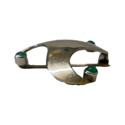 Vintage sterling silver brooch in a Celtic swirl design. Minimalist brooch in a stylised Celtic triple point swirl with a chrysoprase stone in emerald green to the tip of each. Full hallmark to the back and made by Brian de Staic. Photo of brooch seen from the side showing the depth.