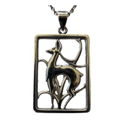 Vintage deer pendant and chain in Danish silver. Very elegantly designed pendant of a deer against foliage. Hallmarked to the back for 830 silver and signed E&M (Eiler & Marloe). The chain is hallmarked for 835 silver. Pendant drop length 50mm and width 30mm. Close up photo of the pendant seen from the front.