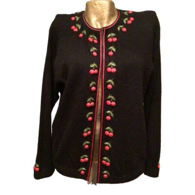 1950s Black lambs wool cardigan with red cherries detail around the neck, along the hook and eye fastening at the front and around the cuffs. Fully lined with no faults in perfect condition, good size 12/14….Rockabilly Swing. Main photo of cardigan seen with front facing forward. The hooks and eyes are done up to show the row of cherries all round the neck and down the front.