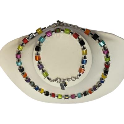 Necklace and bracelet set by Coeur de Lion. Colourful necklace and bracelet both with vibrant cubed crystal glass beads. Evokes images of sun, sea & summer! Necklace measures 410mm at shortest and can be extended to 450mm. Bracelet measures 185mm extendable slightly to 205mm. Photo of both necklace and braccelet displayed on a stand and seen looking down from above. The bracelet is on the top of stand.