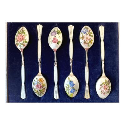 Vintage Henry Clifford Davis Birmingham silver and enamel boxed set of 6 coffee spoons hallmarked c1959. Beautiful enamel detail with a different flower design to back of each spoon. There is a slight blemish of the enamel to one spoon at the handle. Each spoon measures 80 x 0.5 x 15 mms. The measurements below are for the box. Main photo zoomed in to show all 6 spoons inside the fitted case with the enamel decoration side up. Each spoon has a different floral enamel decoration all of which are beautiful!