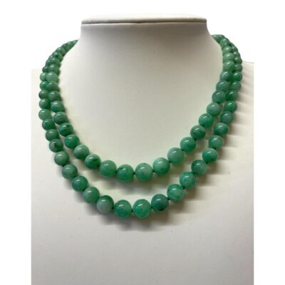 Double row jade bead necklace. Antique necklace with 2 rows of graduating jade beads, each individually knotted. Gold clasp. Shorter row measures 380mm and longer one is approximately 400mm. Main photo of necklace displayed on a stand and seen front facing.