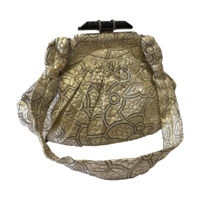 Art Deco fabric evening bag. Lovely small evening bag in a patterned beige fabric and a carved jet clasp with marcasite embellishment. The bag interior has some signs of wear with some stains and tearing of the lining. It houses an attached coin purse located in centre of bag and a small side pocket with a cloth covered small mirror enclosed. The mirror is very cloudy. Drop length approximately 310mm and width 190mm. Depth can extend to around 80mm. Main photo of bag shown upright and from the full side with handle laid to the front.