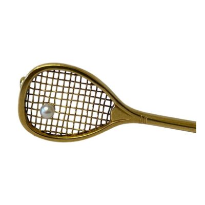 French tennis racket brooch in 18 karat gold. Antique French brooch in the form of a tennis racket with a seed pearl to the head as a ball c1880. There are 2 worn marks, one to the pin and other to the pin hook. The pin extends further than the racket. Weight 2gms. Close up photo of the racket head with the pearl on the end of the netting.
