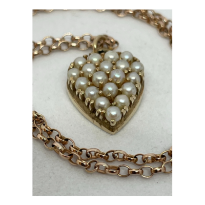 9 karat seed pearl heart pendant and chain. Pretty yellow gold heart pendant set with seed pearls on a 9 karat rose gold chain. Hallmark to the chain clasp only no hallmark to the pendant. Small hole to one side of pendant. Heart pendant drop length 20mm. Close up photo of the seed pearl heart pendant and parts of the chain also shown.