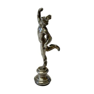 Small statue of Hermes in sterling silver. Very finely detailed small statue of Hermes in his most known pose. Top of his staff or caduceus (kērykeion) is unfortunately missing although this does not detract from the quality of the piece. Hallmark to the back is worn but dates for c1981. (Could also be used as a pipe tamper) Weight 40gms. Main photo of statue faced towards the left and shown in full body profile. The right arm and foot are both raised with the right arm above the head and right leg bent with foot sticking out to the back. The missing caduceus is clearly shown with only the base of it visible in the left arm.