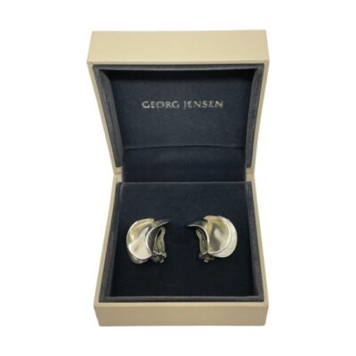 Georg Jensen silver clip-on earrings c1990s. A generous sized pair of modernist sterling silver clip-on earrings designed by Nanna Ditzel for Georg Jensen. Comes in original box. Both clips are in good working order. Hallmarked Georg Jensen 925 with No367 to the base of the clips and import silver mark to back of earrings. Measures 28mm by 25mm. Main photo of earrings displayed inside the original Georg Jensen box. The earrings are laid on their side and Georg Jensen mark is visible inside the lid.