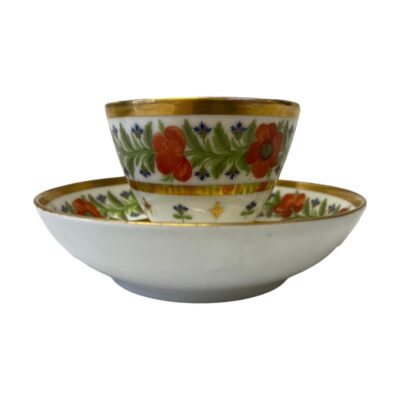Porcelain coffee can and saucer by Paris. Late 19th century cup and saucer set decorated with poppies and thistles and finished with gold leaf accent. In very good condition with only minor gilt wear around the cup rim & a few dark dots in the bottom of the cup. Cup measures 42mm in diameter at base, 78mm across the top and 60mm tall. Saucer measures 80mm in diameter at base, 128mm across the top and 35mm deep. Main photo of cup siting on the saucer and seen from an eye level. Owing to the depth of the saucer, the bottom half of the cup is obscured as is the pattern on the saucer.
