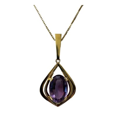 14 karat gold chain with amethyst pendant. Classically stylish 14 karat gold pendant with a modern twist, set with a large oval cut amethyst. Hallmarked to back of pendant and to chain clasp and ring hook. Pendant measures 67mm long and 28mm at widest. Close up photo of the pendant which is forward facing.