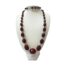 Art Deco cherry bakelite necklace. Lovely Art Deco graduating faceted cherry bakelite necklace with metal links separating each bead. There is no clasp as necklace is long and can fit over the head. The largest bead measures 30mm long and 20mm wide. 60 grams. Main photo of necklace displayed on a stand. As the necklace is long it has been twisted round the neck of the display stand. The largest bead is at the front centre.