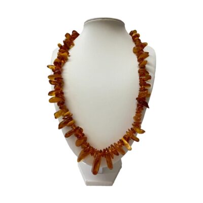 Vintage Baltic amber necklace. Nice length Baltic amber necklace with mostly cognac amber and the occasional butterscotch and egg yolk pieces. Amber screw clasp. The largest piece at the front measures 30mm long. 62gms. Main photo of necklace displayed on a stand and seen forward facing.