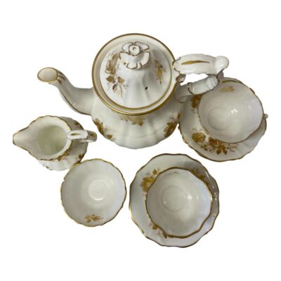 Coffee/tea service for 2 by Hammersley. White and gold set in Golden Glory pattern consisting of a coffee pot, jug, sugar bowl, 2 cups and 3 saucers (1 spare!) Very elegant set in white with gold roses and trim c1950s. All pieces are in excellent condition with a lovely ringing sound when pinged, no chips, cracks or crazing. Minor gilt wear around jug spout and rim of both tea cups. The pot measures 98mm in diameter at base, 210mm at longest across spout & handle, 145mm at widest and 220mm tall with lid. Sugar bowl measures 55mm in diameter at base, 95mm across top and 53mm tall. Jug measures 55mm in diameter at base, 112mm long at spout and handle, 85mm wide and 112mm at tallest (handle). Cups measure 43mm at base, 96mm across top, 108mm long to handle and 58mm high. Saucers measure 145mm in diameter and 18mm high. Photo of the whole set seen looking straight down from above.
