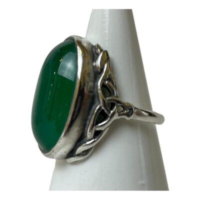 Silver ring set with a chrysoprase cabochon. Beautiful large chrysoprase cabochon set in silver with Celtic inspired rope work to the shoulders. Stone measures 20mm by 12mm. Ring size L / 5.75. Photo of ring on a cone shaped stand and seen with ring front facing left. The Celtic knotwork detail to the shoulder area is clearly visible.