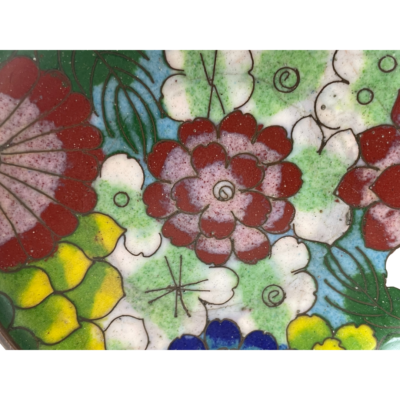 Antique Chinese cloissoné dish. Small late 19th century cloisonné dish with a pretty multi coloured floral theme to the centre. Airforce blue and green to the base. A few small manufacturer dips in the enamel. Measures 80mm in diameter at top and 45mm at the base. Close up photo of the centre floral detail of the dish.