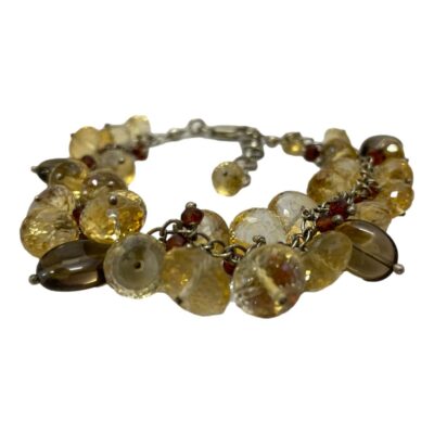 Sterling silver quartz crystal bracelet. Vintage bracelet set with faceted quartz, smoky quartz and tiny faceted cranberry quartz beads. Hallmarked 925 to the clasp. Length adjustable from 185mm to 215mm. Photo of bracelet laid on a flat surface and seen from a near eye level.