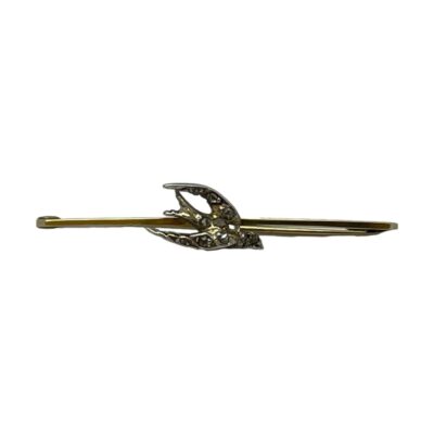 Antique bar brooch with a swallow to the centre. Sweet Edwardian bar brooch in unmarked 9 karat gold with a silver swallow encrusted with rose cut diamonds. The pin closes a little loose and needs attention. Main photo of brooch seen from the front with the swallow bird to the centre of the bar