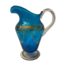 Antique Bohemian glass jug. Pretty vibrant blue jug with hand painted gilt and floral decoration. Clear glass handle and base. Late 19th century. Base measures 95mm in diameter, 185mm from spout to handle, 110mm wide and 205mm at tallest. Main photo looking at the jug from an eye level side angle with the spout to the left and handle at right. The jug is made with the spout higher than the handle.