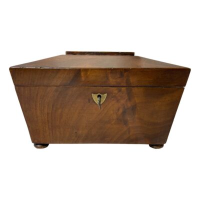 Georgian tea caddy. A fine quality 2 compartment Georgian sarcophagus tea caddy in rosewood on 4 feet with working lock and key. The compartments have been stripped of their lining. There are some signs of wear consistent with age including a crack in the wood at the base. Main photo of caddy seen from an eye level and from the front. 2 ball feet are visible at the bottom front and the caddy has a roof top shaped lid.
