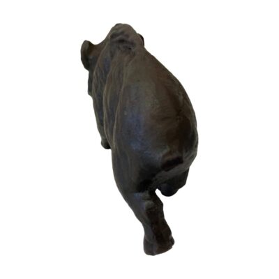 Iron wild boar figure. Very heavy solid small wild boar made entirely of iron. Minimalist detailing which still emits the features of a wild boar. Heavy item for collection from store only. Photo of boar seen from behind and at a raised angle. The rear end is in the bottom foreground slightly to the right while the head is to the centre top.