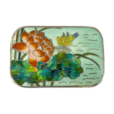 Korean silver box with enamel decoration. An ample sized 980 silver box decorated with enamel to the lid. The enamel decoration is of a beautiful blooming lotus flower with a water fowl in the background. There are some signs of enamel wear especially around the sides of the box. There is also a dint in the top left corner of lid by the lotus flower with some missing enamel and some small cracks in the enamel water to the right. Hallmarked Made in Korea Silver 98% to the base. 78grams. Photo showing the enamel lid only. Lovely vibrant red lotus flower on the top left with lush blue, green & yellow foliage below and extending to the right. A yellow and blue water fowl is seen in the background with aqua blue enamel filling for the water.