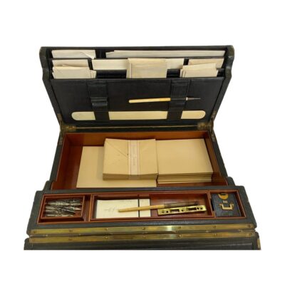 Antique writing slope with stationery box from early Edwardian era. c1901-1904 leather bound mahogany wood writing slope including a leather bound ink bottle with clasp in excellent working order. There are several pieces of personalised stationery inside along with a page turner, ink pens and quills. The writing slope is on opposing side of the stationery and within the slope compartment, there is a leather bound blotter pad. The underside of the slope has a criss-cross of perishing elastic which would have been used to hold letters or documents. There is a laminated full detailed information about the item inside along with a history of the Bramah Lock Company. A truly wonderful historic piece with many stories to tell! Large heavy item - for collection from shop only. Photo looking down into the stationery area of the box. The upright to the back is full of envelopes and writing paper with slots in the front which has one quill pen end and a page turner. There are monogrammed envelopes and writing cards in the central section and to the front the section holding inkwell & pen quills.
