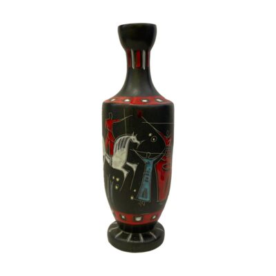 Retro jug by Gianni Tosin. Striking Etruria Arte ceramic vase by Gianni Tosin, Italy c1960s. Main body in matt black with figures in gloss red, blue and yellow and a fine horse in white. The scene is open to interpretation. We interpret it as a scene of love, music & sunshine. Single handle to the top. Measures 77mm in diameter and 46mm at top. Photo of vase with the handle hidden behind. The image visible is the front end of the white horse with an archer dressed in red standing on the horses back with arrow poised to shoot. There is a small figure in blue standing in front of the horse and part of a taller figure in red with arms outstretched. The arm on view is holding a stick with what looks like a heart on the end which the archers arrow is pointing at.