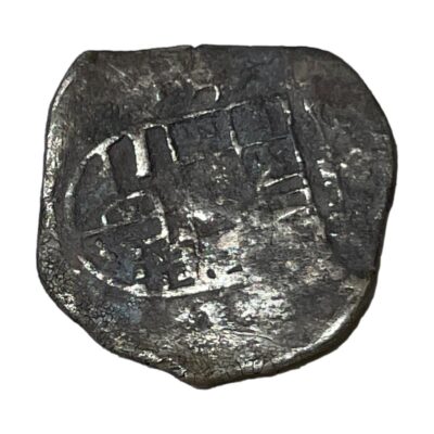 Felipe III 2 Reales coin c1599. Antique silver coin with partially visible images. This coin is not even in size or depth possibly due to age or manufacture method of the time. Measures approximately 25mm and 27mm at widest. Protective plastic coin case included. Photo of the reverse (back) side of coin with an image of either a shield or door just visible.