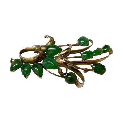 14 karat gold spray brooch with jade. Vintage 14 karat gold spray brooch with jade c1950s. Secure fastening barrel clasp. Hallmarked 14kt to the back. Main photo of brooch seen fully forward facing. The gold is designed in a flower spray fashion with stunning apple green jade stones in circular, oval and teardrop shape. The brooch is laid on its side but can be worn any way up!