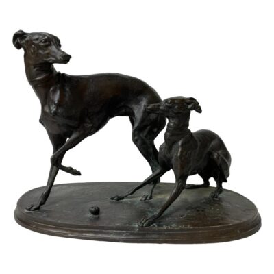 Signed bronze of greyhounds by Mene. A wonderful bronze of an adult & juvenile greyhound in a playful pose. Signed Mene to the top of the base. Measurements 205mm longest, 110 widest and 145mm tallest. Weight 1560 grams. Collect from store only. Main photo showing the greyhounds from a side angle with the juvenile pup in the foreground. It is looking at the adult which is posed ahead of the pup and in the background facing backwards at the pup. The pose of these piece is very realistic showing a pair of playful greyhounds mid stride. There is n0o base stand on this item although may have been one in the past.