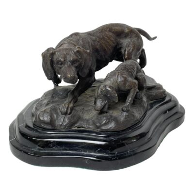 A signed bronze of hunting dogs. Handsomely made bronze of an adult hunting dog with pup, the adult being on high alert. Signed Barye to the base of the bronze which is set on marble. The signature is unverified hence listing as inspired by Barye. Measures 225mm at longest, 150mm at widest and 105mm at tallest. Weighs 2960grams. Collect from store only. Main photo of bronze seen with adult dog looking towards the camera while the pup has head down drinking or eating. The bronze is displayed at a diagonal angle
