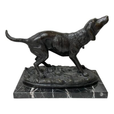 Signed bronze dog on marble base. A fabulous bronze of a setter dog in a sweet pose set on a black marble base. Signed Milo to the bronze base with a bronze guarantee disc attached on opposing side to signature. Dog measures 260mm from tip of nose to tail and 190mm tall. The marble base measures 245mm long, 125mm wide and 20mm high. Collect from store only. Main photo of dog seen from a side angle with head slightly towards camera and to the right of photo. The pose is very realistic with the dog seemingly asking for something.