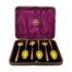 Main photo of the spoons displayed inside the case. All spoons are bowl side down to show the vibrant yellow guilloche enamel. The inside of the case is a royal purple is a very complimentary contrast colour to the yellow of the spoons.